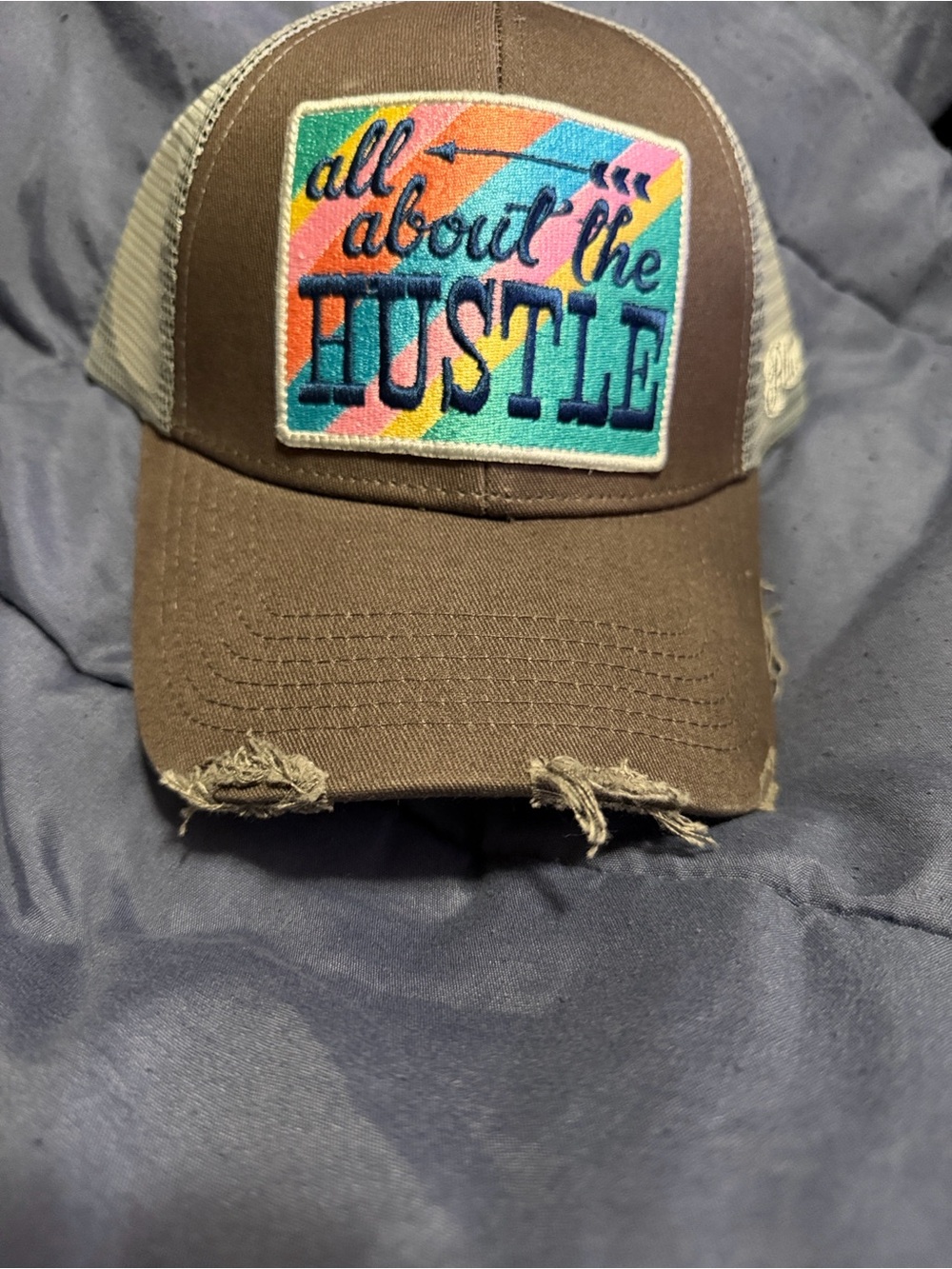 Plunder Brown Trucker Hat with Colorful 'All About the Hustle' Patch